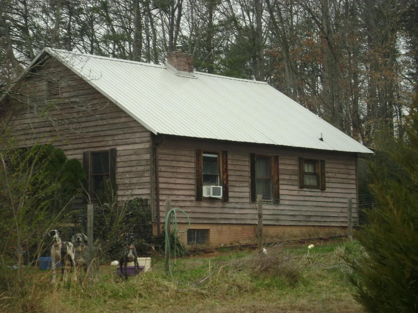 White metal roof on an old wood sided farmhouse, from a Metal Roof Installation job in Cumberland City